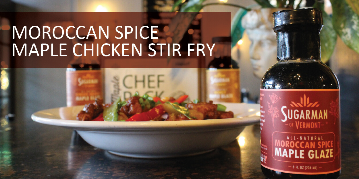 A bottle of Moroccan spice maple glaze beside a chicken stir fry on a plate.